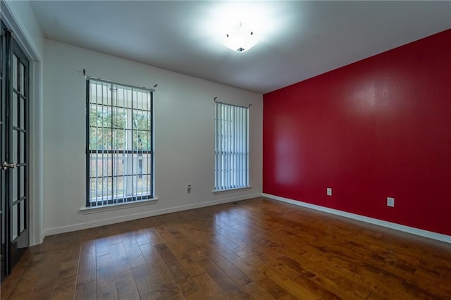 unfurnished room with wood-type flooring