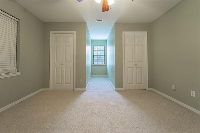 9075 Hamm Cir, Wilmer, AL 36587 - unfurnished bedroom with light carpet, a ceiling fan, and baseboards