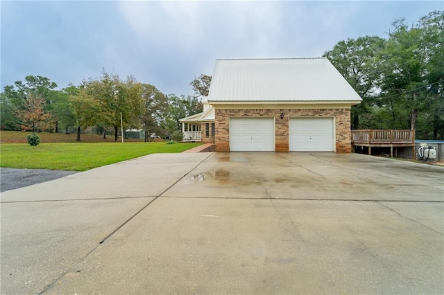 view of property exterior featuring a yard and a garage