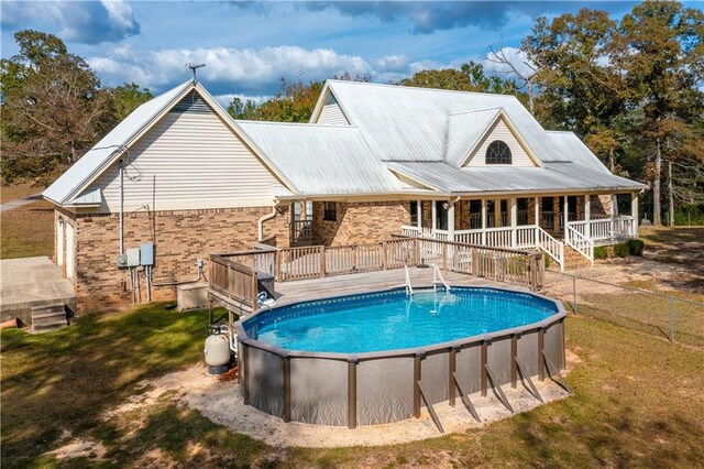 view of pool featuring a lawn