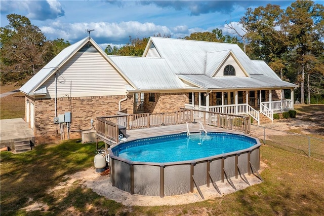 9075 Hamm Cir, Wilmer, AL 36587 - rear view of property featuring an outdoor pool, metal roof, and a deck