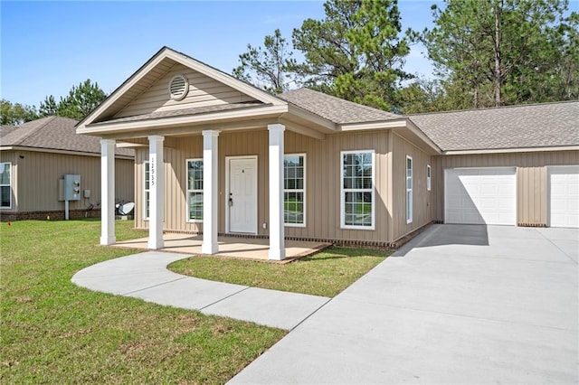 view of front of home with a porch, a garage, and a front yard