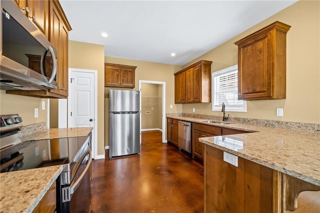 kitchen featuring light stone countertops, sink, and stainless steel appliances