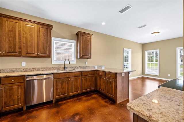 kitchen with dishwasher, light stone counters, kitchen peninsula, and sink