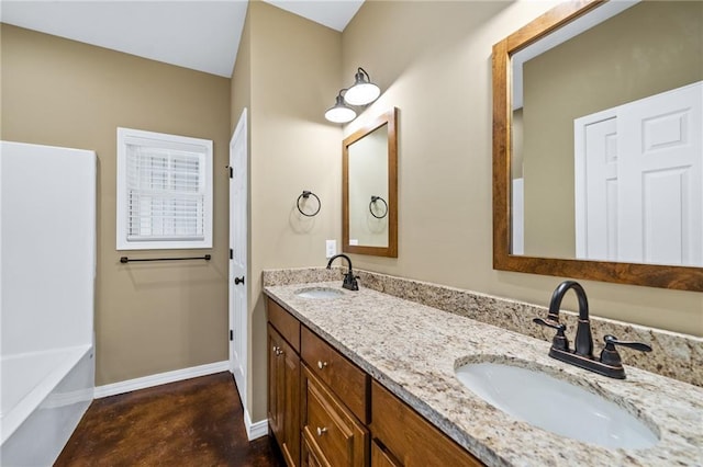 bathroom featuring vanity, a tub to relax in, and concrete floors