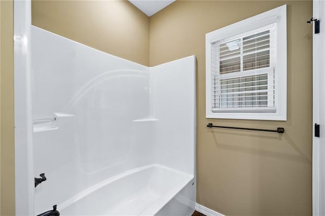 bathroom with shower / washtub combination