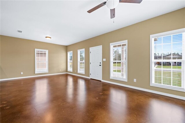 unfurnished room featuring ceiling fan and concrete flooring