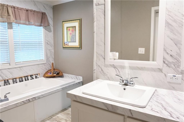 bathroom with a bath to relax in, tile walls, and large vanity