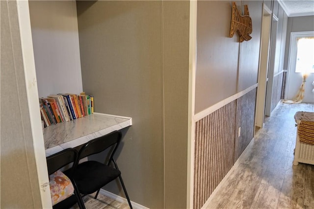 hall featuring hardwood / wood-style flooring and crown molding