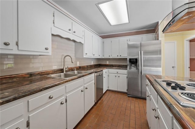 112 Meadow Wood Dr, Daphne, AL 36526 - kitchen featuring a sink, stainless steel appliances, ventilation hood, dark countertops, and brick flooring