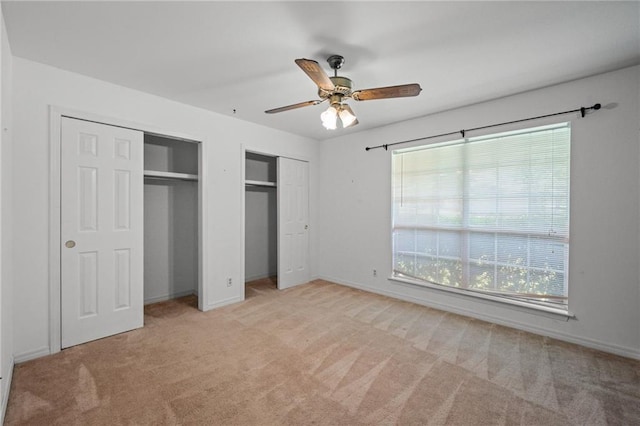 112 Meadow Wood Dr, Daphne, AL 36526 - unfurnished bedroom featuring multiple closets, multiple windows, light colored carpet, and baseboards