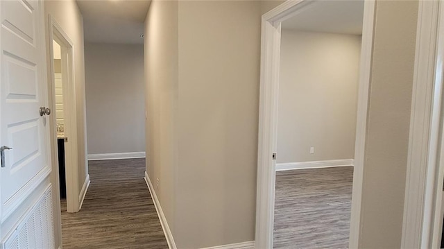 hallway with dark wood-type flooring