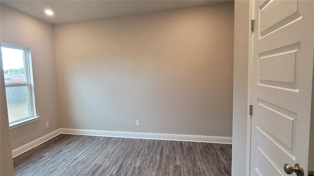 empty room with dark hardwood / wood-style flooring