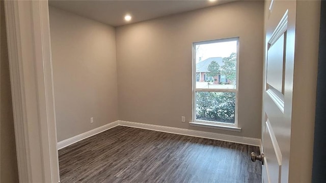 empty room featuring dark wood-type flooring