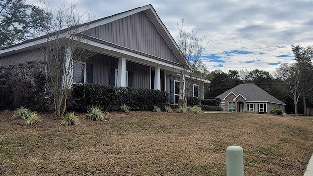 view of side of home with a yard