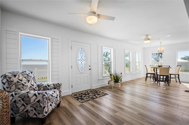 entryway with hardwood / wood-style flooring, ceiling fan, and a water view