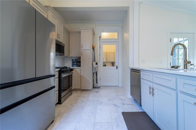 7 Reed Ave N, Mobile, AL 36604 - kitchen featuring stainless steel appliances, a sink, crown molding, and light countertops
