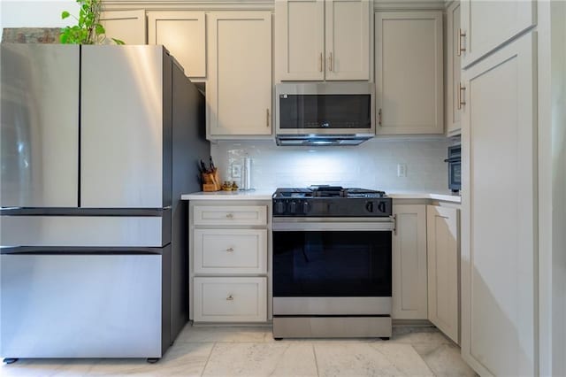 7 Reed Ave N, Mobile, AL 36604 - kitchen with stainless steel appliances, light countertops, and tasteful backsplash