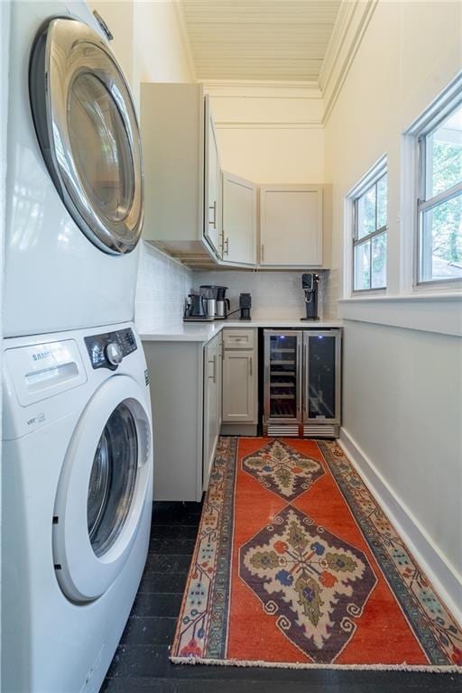 7 Reed Ave N, Mobile, AL 36604 - laundry room with stacked washing machine and dryer, wine cooler, ornamental molding, and baseboards