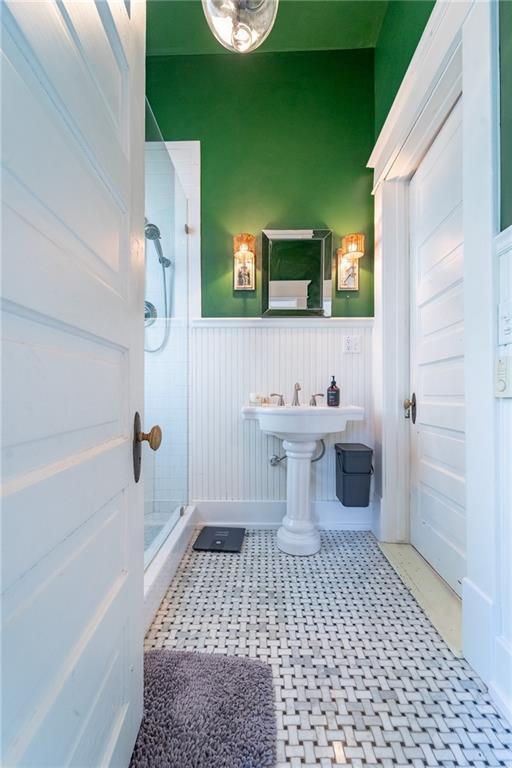 7 Reed Ave N, Mobile, AL 36604 - full bathroom with a stall shower and a wainscoted wall