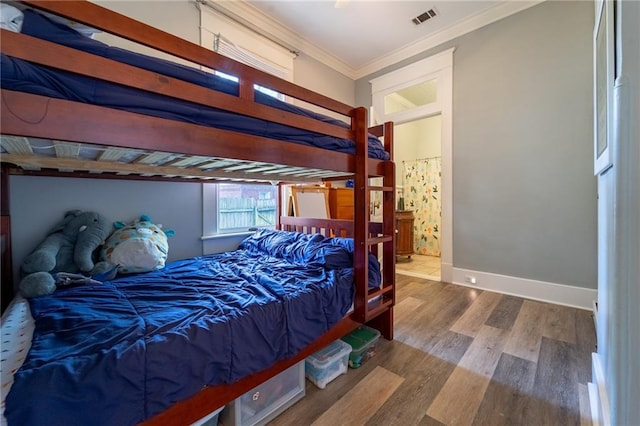 7 Reed Ave N, Mobile, AL 36604 - bedroom featuring wood finished floors, ornamental molding, baseboards, and connected bathroom