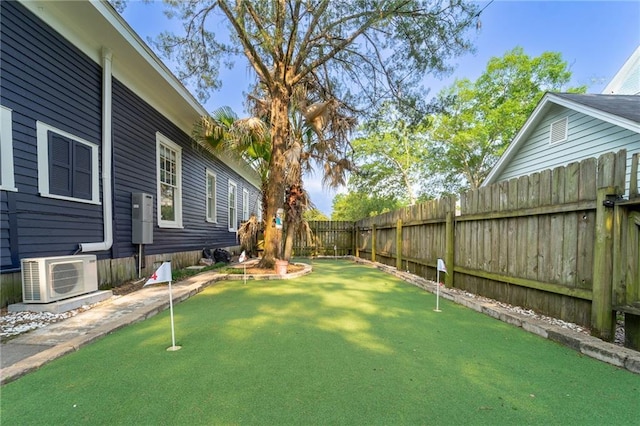 7 Reed Ave N, Mobile, AL 36604 - fenced backyard with a cooling unit and a putting area