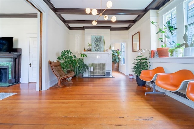 7 Reed Ave N, Mobile, AL 36604 - sitting room with a fireplace, wood-type flooring, beamed ceiling, baseboards, and a chandelier