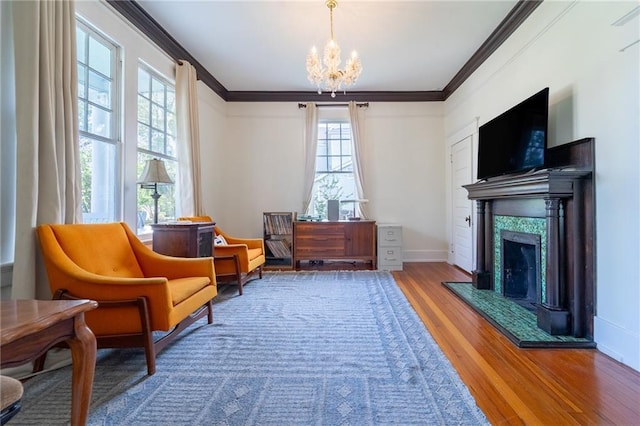 7 Reed Ave N, Mobile, AL 36604 - living area featuring wood finished floors, crown molding, a chandelier, a tile fireplace, and baseboards