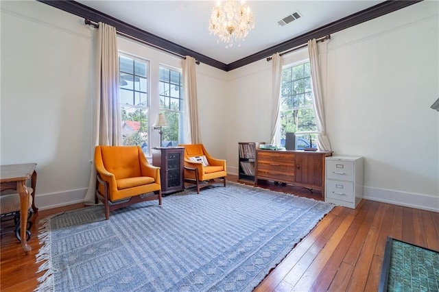 7 Reed Ave N, Mobile, AL 36604 - sitting room featuring plenty of natural light, a chandelier, baseboards, wood-type flooring, and ornamental molding