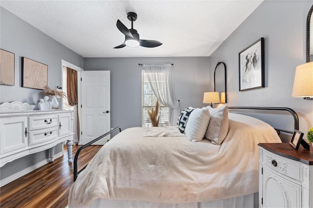 901 La Mothe Pl, Dauphin Island, AL 36528 - bedroom with a ceiling fan, dark wood-style flooring, and a textured ceiling