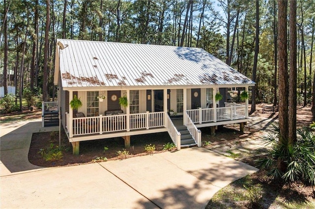 901 La Mothe Pl, Dauphin Island, AL 36528 - view of front of home featuring metal roof and a porch