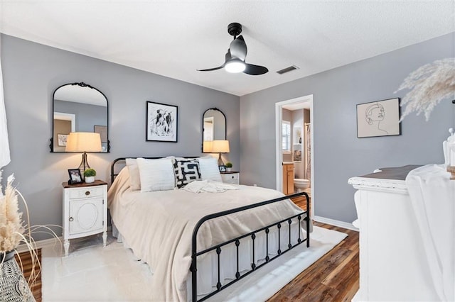 901 La Mothe Pl, Dauphin Island, AL 36528 - bedroom featuring a ceiling fan, wood finished floors, baseboards, visible vents, and connected bathroom