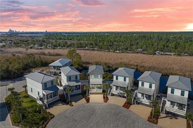 2455 Saltgrass Way, Orange Beach, AL 36561 - aerial perspective of suburban area featuring a heavily wooded area