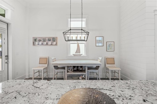 2455 Saltgrass Way, Orange Beach, AL 36561 - dining space featuring plenty of natural light, baseboards, and wood finished floors