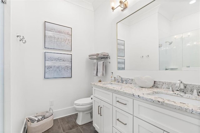 2455 Saltgrass Way, Orange Beach, AL 36561 - full bathroom with a shower stall, toilet, double vanity, baseboards, and tile patterned flooring
