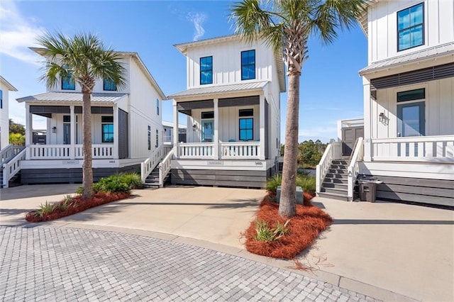 2455 Saltgrass Way, Orange Beach, AL 36561 - view of front of house featuring a porch, board and batten siding, and stairway