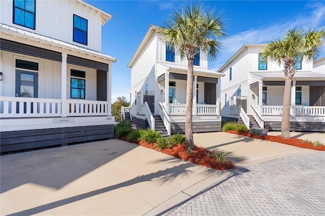 2455 Saltgrass Way, Orange Beach, AL 36561 - view of front of property featuring a porch, board and batten siding, and driveway
