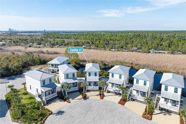 2455 Saltgrass Way, Orange Beach, AL 36561 - aerial perspective of suburban area with a heavily wooded area