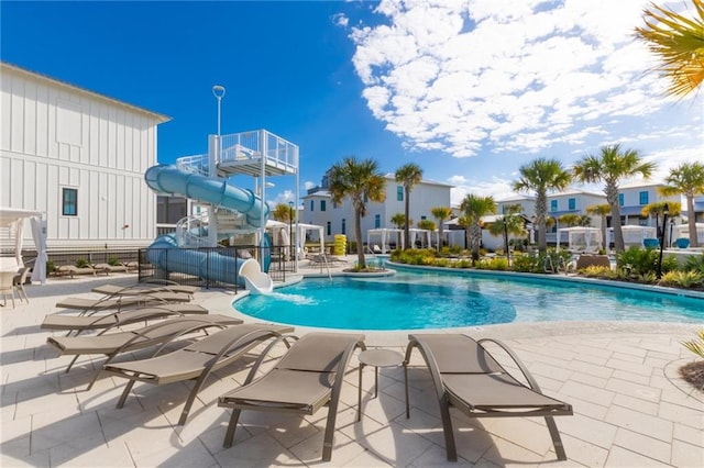 2455 Saltgrass Way, Orange Beach, AL 36561 - community pool with a water slide, a patio area, and a residential view