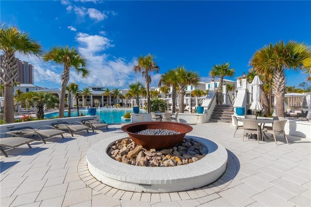 2455 Saltgrass Way, Orange Beach, AL 36561 - view of patio with a community pool, a fire pit, and stairs
