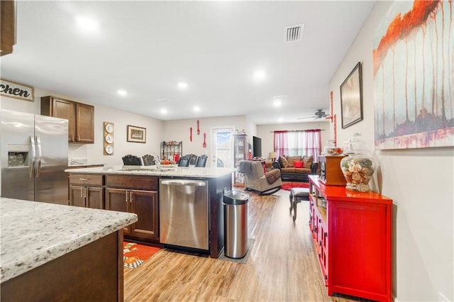 kitchen with sink, light hardwood / wood-style floors, ceiling fan, and appliances with stainless steel finishes