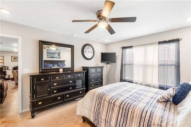 bedroom featuring ceiling fan and light carpet