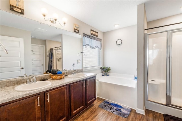 bathroom featuring vanity, wood-type flooring, and independent shower and bath