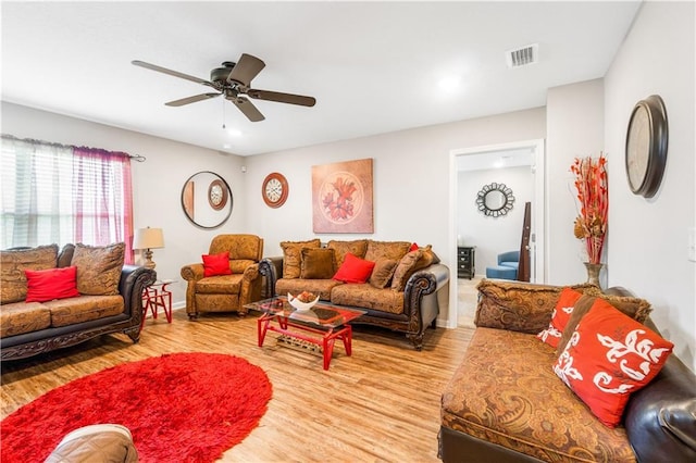 living room with ceiling fan and light hardwood / wood-style flooring