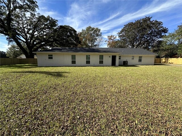 back of house with a lawn and cooling unit