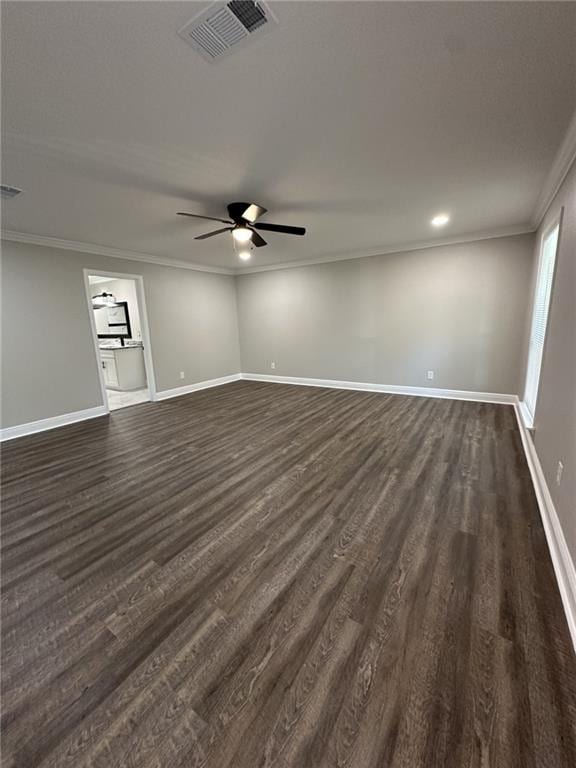 empty room with ceiling fan, ornamental molding, and dark wood-type flooring