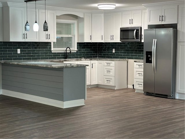 kitchen with white cabinetry, dark wood-type flooring, stainless steel appliances, pendant lighting, and stone countertops