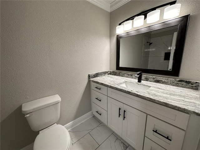 bathroom with crown molding, vanity, and toilet