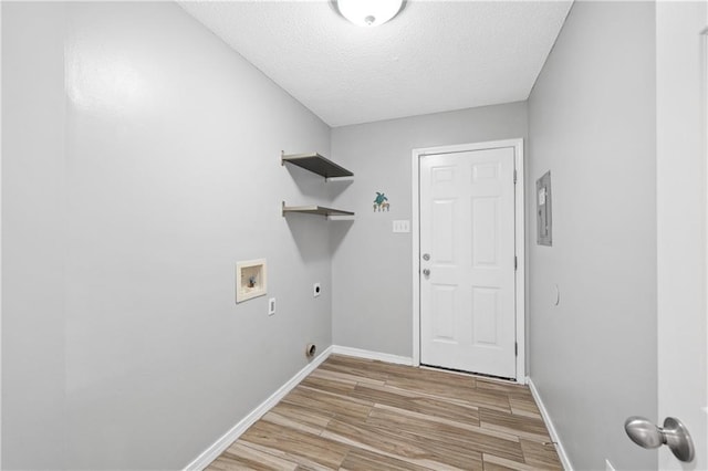 laundry room featuring baseboards, light wood-type flooring, washer hookup, laundry area, and hookup for an electric dryer