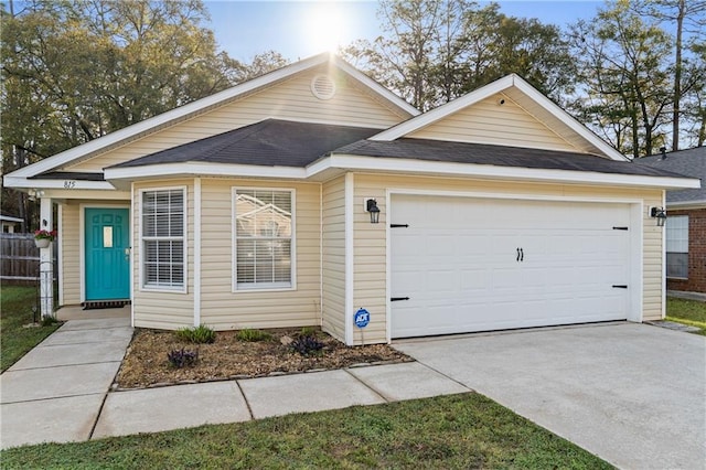 ranch-style house with an attached garage, driveway, and roof with shingles